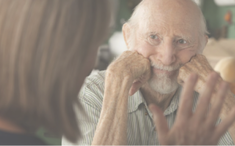 Elderly Man Having Conversation With Woman