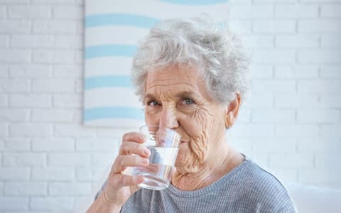 Elderly Woman Drinking Water From A Glass