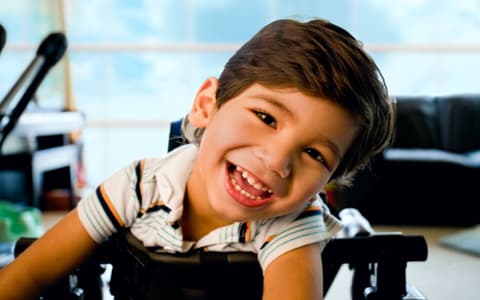 Less Abled Young Boy In Wheelchair Smiling