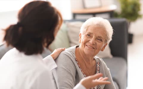 Carer Speaking To Elderly Woman