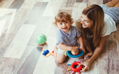 Mother Playing With Young Child On Floor