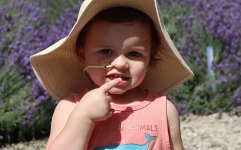 Young Child Wearing A Hat With Feeding Tube In Nose