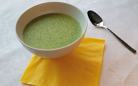 Soup In A Bowl In Table With Yellow Napkin