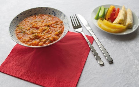 Food In Bowl On Table With Cutlery