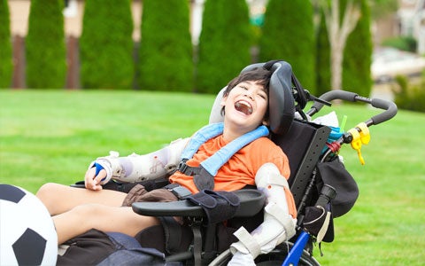 Less Abled Young Boy In Wheelchair Smiling